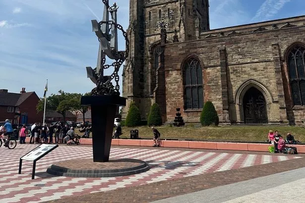 The new look St Editha's Square with the church in the background and Colin Grazier Memorial set in a new look paved area 