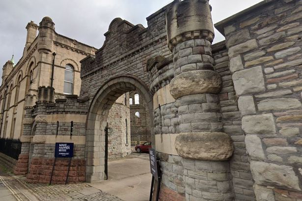 Stone archway in front of car park