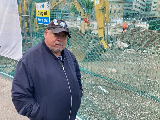 Stuart Parker, watching the construction work going on in Ashton's Market Square