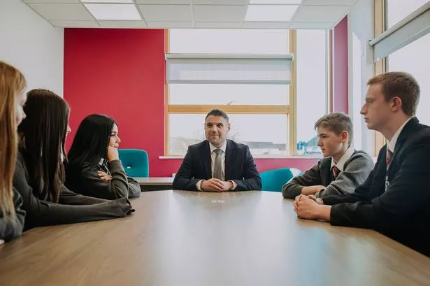Headteacher at Merchants Academy, Guy Swallow, conducts a meeting with pupils
