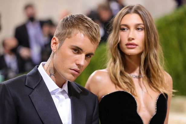 Justin Bieber in a black suit and Hailey Bieber in a black dress at the Met Gala 2021.