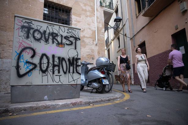 Anti-tourist graffiti reading "Tourist Go Home" in Palma de Mallorca.