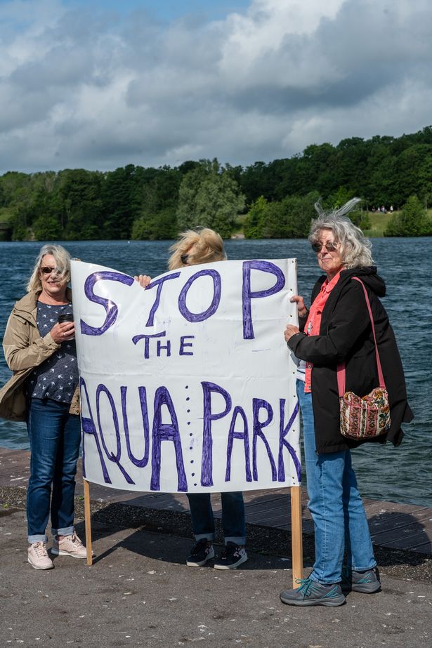 Three women holding up a sign