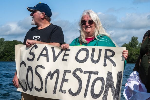 A couple holding a sign