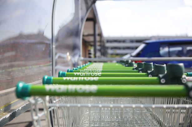 Haywards Heath, England - June 22, 2019: Waitrose branded shopping carts stacked in a queue, ready for customers. Narrow depth of focus.