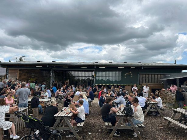 People sit outside at Diddly Squat Farm Shop