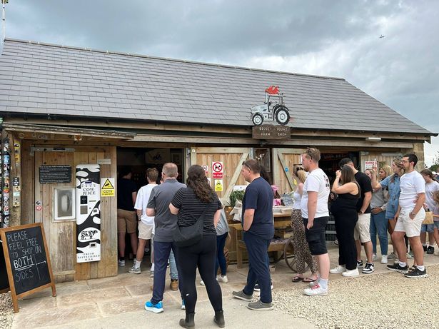 People wait to get in at the entrance to the Diddly Squat Farm Shop
