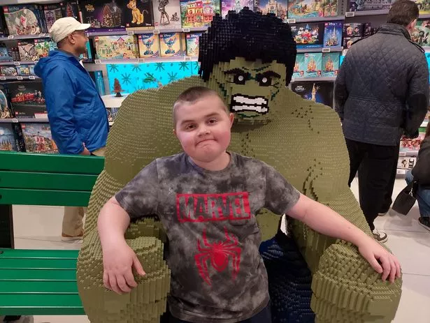 Harry Reid at the Lego store with a life size Hulk 