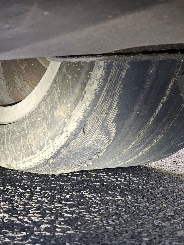 Car with a bald tyre