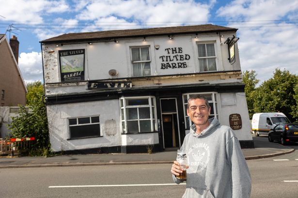 A man with a pint outside a pub