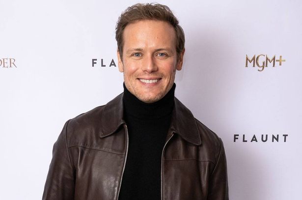 Sam Heughan in a black leather jacket