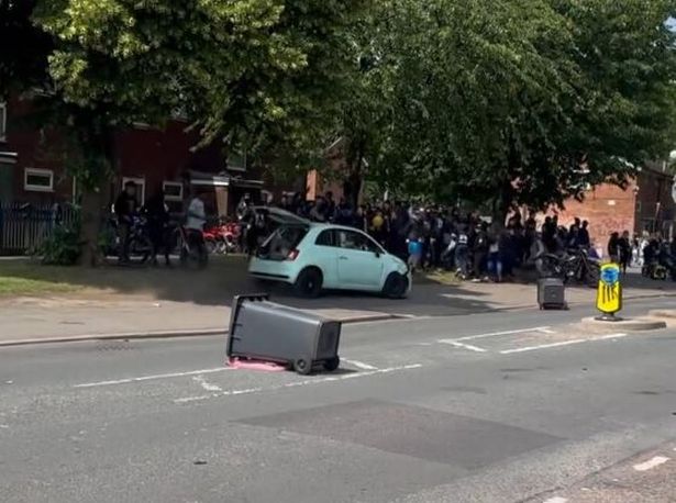 The white Fiat drove dangerously close to the crowd