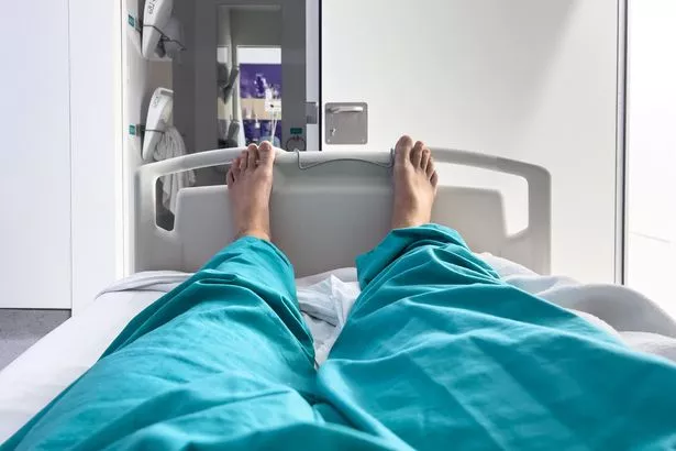 Back view of a patient in a hospital bed