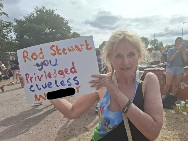 Lisa stages a one woman protest against Rod Stewart at Glastonbury Festival