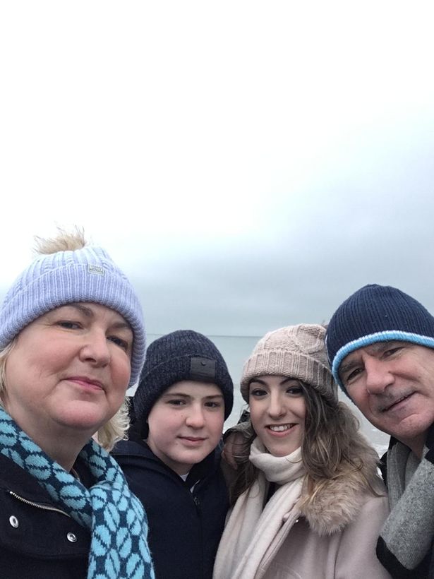 A family of  four wearing wooly hats