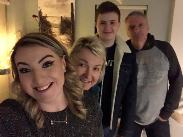 A family of four smiling