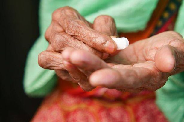 senior women taking medical pill