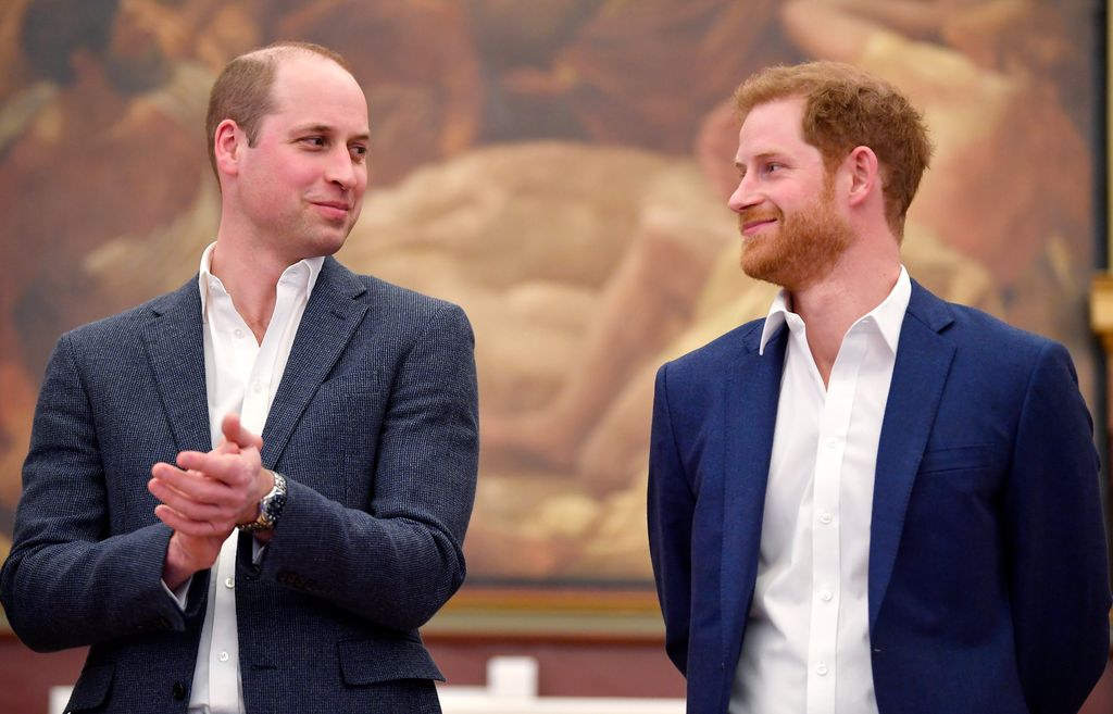 Prince William and Prince Harry smirking at each other