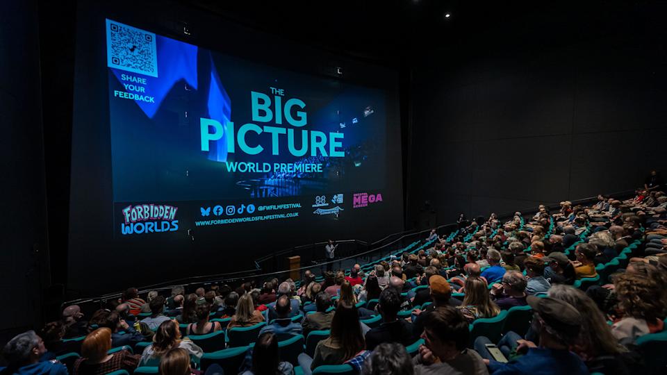 A large group of people sit in large cinema during the Forbidden Worlds Film Festival in Bristol