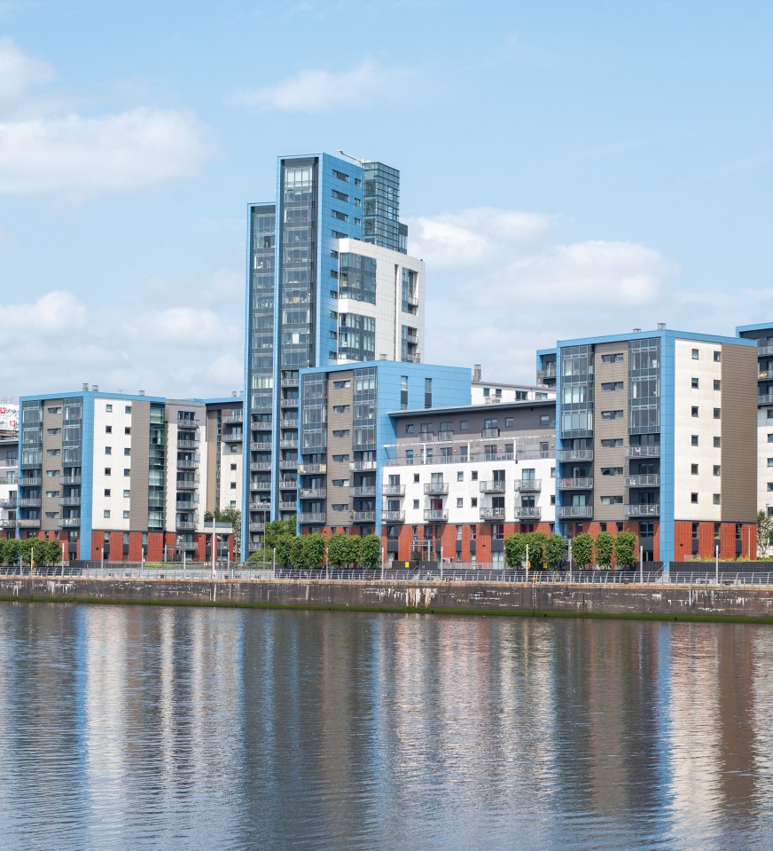 Glasgow Harbour flats reflected in water.
