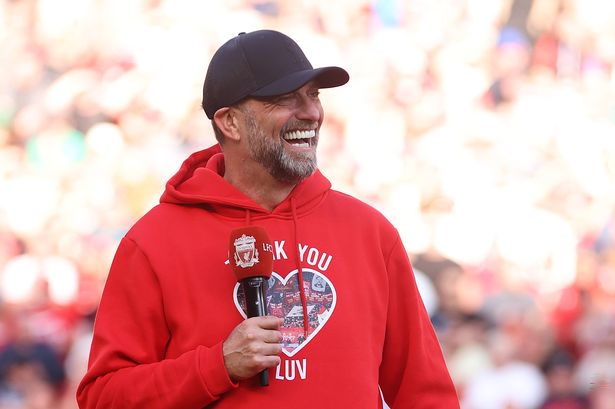 LIVERPOOL, ENGLAND - MAY 19: Jurgen Klopp, Manager of Liverpool, wearing a 'Thank You Luv' hoodie, speaks to the fans following his final match as Liverpool manager after the Premier League match between Liverpool FC and Wolverhampton Wanderers at Anfield on May 19, 2024 in Liverpool, England. (Photo by Clive Brunskill/Getty Images)