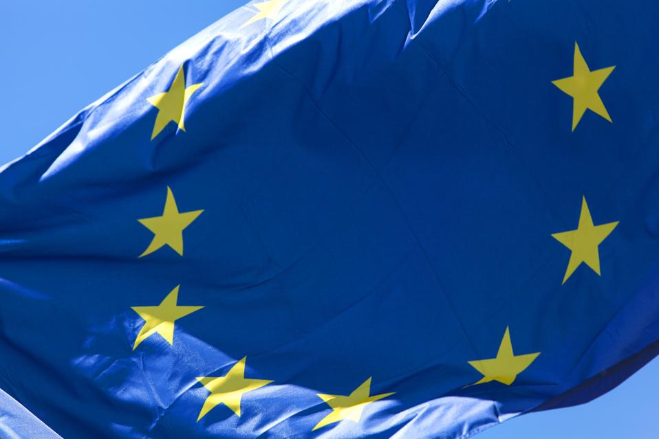European flag in close up, in front of blue sky