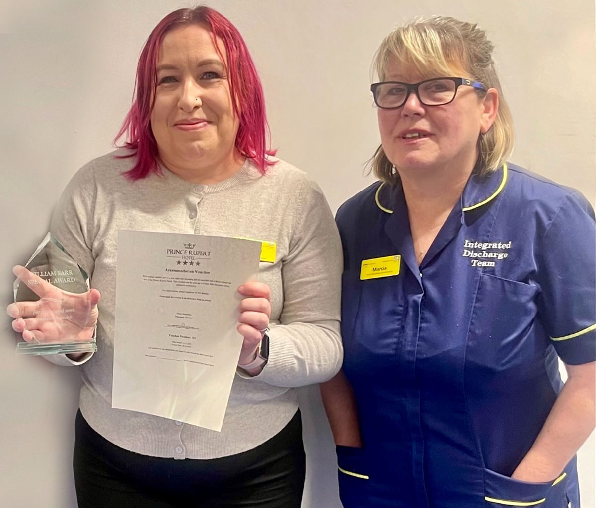 Natalie Chambers, left, with her award for helping the homeless, alongside colleague Marcia Coutts