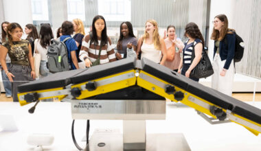 Students gathered around an exhibit of a medical device in the Science Museum in London.