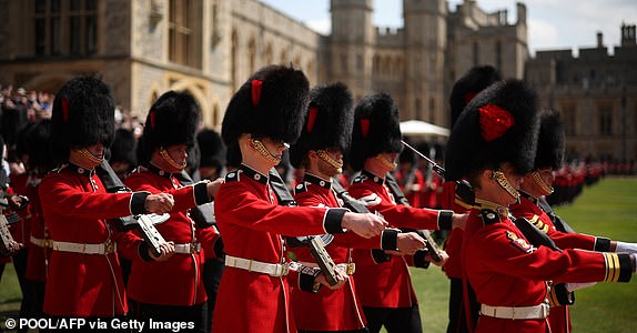 Members of The Coldstream Guards march during ceremony to present new Colours to the 1st and 2nd Battalion (Number 7 Company) the Coldstream Guards at Windsor Castle, west of London, on June 13, 2025. One of the new Colours will be carried by Number 7 Company in the Trooping of the Colour at The King's Birthday Parade in London on Saturday June 14, 2025. (Photo by HENRY NICHOLLS / POOL / AFP) (Photo by HENRY NICHOLLS/POOL/AFP via Getty Images)