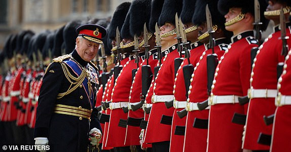 Britain's King Charles III, Colonel in Chief of the Coldstream Guards inspects the regiment during a ceremony where he presents new Colours to the 1st and 2nd Battalion (Number 7 Company) the Coldstream Guards at Windsor Castle, west of London, on June 13, 2025. One of the new Colours will be carried by Number 7 Company in the Trooping of the Colour at The King's Birthday Parade in London on Saturday June 14, 2025.     HENRY NICHOLLS/Pool via REUTERS