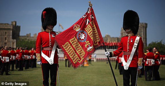 WINDSOR, ENGLAND - JUNE 13: Soldiers of the 1st and 2nd Battalion (Number 7 Company) the Coldstream Guards display the King's Colour at Windsor Castle on June 14, 2025 in Windsor, England. One of the new Colours will be carried by Number 7 Company in the Trooping of the Colour at The King's Birthday Parade in London on Saturday. (Photo by Henry Nicholls - WPA Pool/Getty Images)