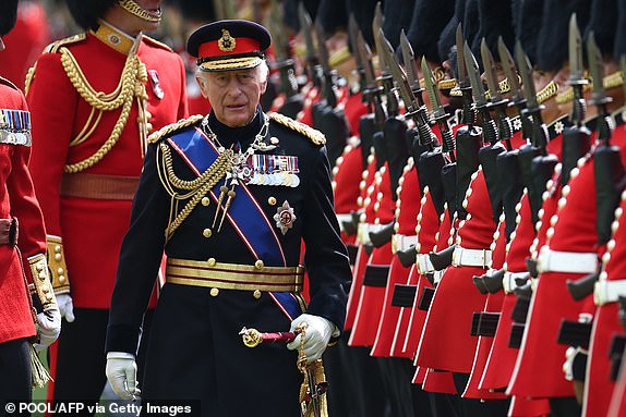 Britain's King Charles III, Colonel in Chief of the Coldstream Guards inspects the regiment during a ceremony where he presents new Colours to the 1st and 2nd Battalion (Number 7 Company) the Coldstream Guards at Windsor Castle, west of London, on June 13, 2025. One of the new Colours will be carried by Number 7 Company in the Trooping of the Colour at The King's Birthday Parade in London on Saturday June 14, 2025. (Photo by HENRY NICHOLLS / POOL / AFP) (Photo by HENRY NICHOLLS/POOL/AFP via Getty Images)