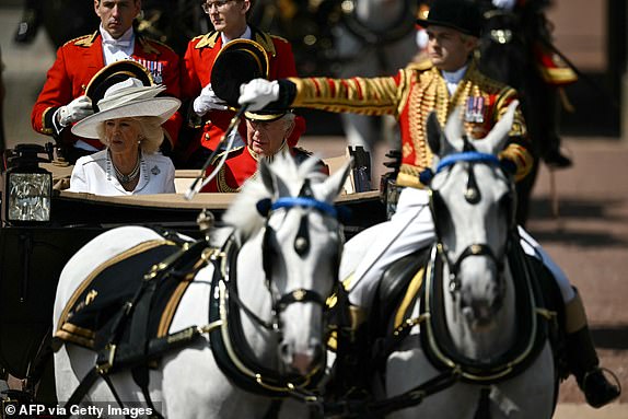 Britain's King Charles III and Britain's Queen Camilla make their way from Buckingham Palace to Horse Guards Parade for the King's Birthday Parade, "Trooping the Colour", in London on June 14, 2025. The ceremony of Trooping the Colour is believed to have first been performed during the reign of King Charles II. Since 1748, the Trooping of the Colour has marked the official birthday of the British Sovereign. Over 1500 parading soldiers and almost 300 horses take part in the event. (Photo by Ben STANSALL / AFP) (Photo by BEN STANSALL/AFP via Getty Images)