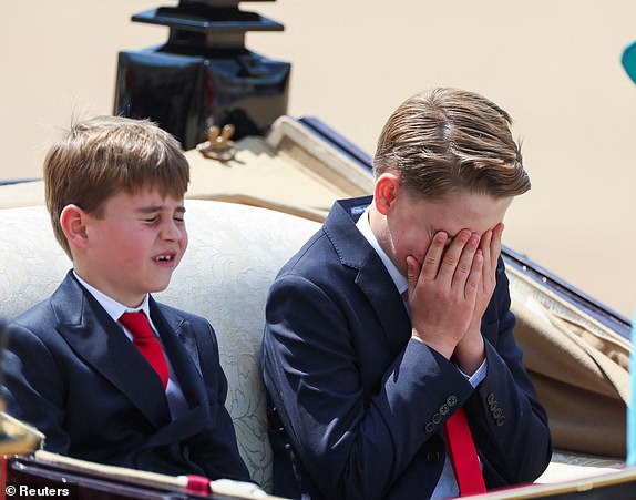 Prince George reacts as he rides a carriage with Catherine, Princess of Wales, Prince Louis and Princess Charlotte (not pictured) as part of the Trooping the Colour parade which honours Britain's King Charles on his official birthday, in London, Britain, June 14, 2025. REUTERS/Isabel Infantes