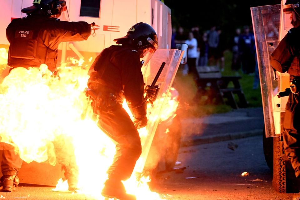 A police officer surrounded by flames as a petrol bomb explodes after violence again broke out in Portadown tonight. Photo: Alan Lewis