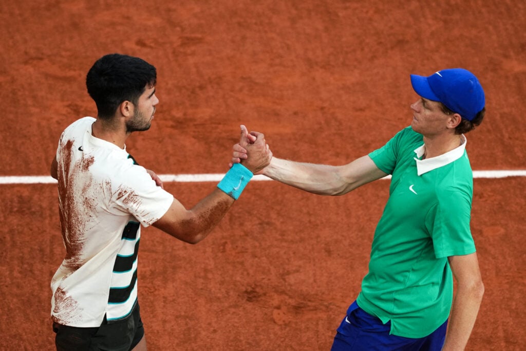 Jannik Sinner and Carlos Alcaraz shake hands after the 2025 French Open final.