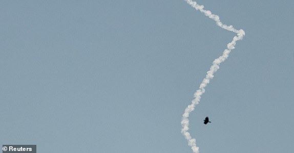 An interceptor missile leaves a smoke trail as missile are launched from Iran towards Israel, as seen from Tubas, in the Israeli-occupied West Bank, June 18, 2025. REUTERS/Raneen Sawafta