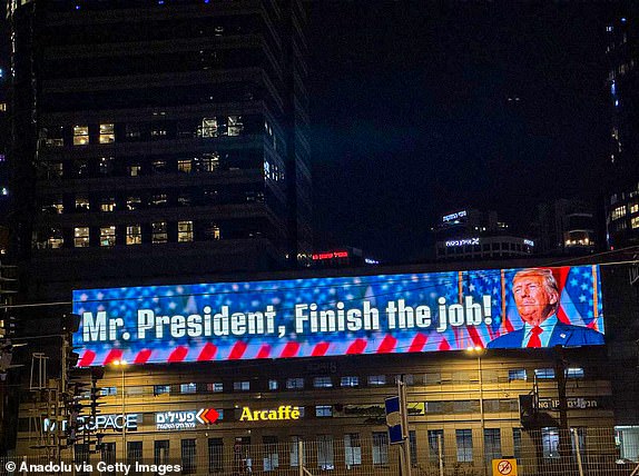 TEL AVIV, ISRAEL - JUNE 19: A view of a digital billboard reading 'Mr. President, Finish the job!' referring to US President Donald Trump on June 19, 2025 in Tel Aviv, Israel (Photo by Enes Canli/Anadolu via Getty Images)