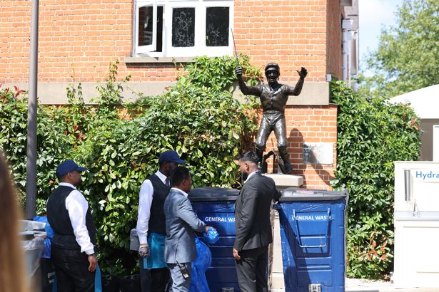 Frankie Dettori statue behind bins at Ascot races  
