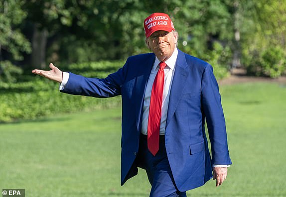 epa12190190 United States President Donald J Trump gestures towards the new flagpole on the South Lawn of the White House as he returns to the White House following an overnight visit to the Trump National Golf Club in Bedminster, New Jersey, in Washington, DC, USA, 21 June 2025. Later, the President is expected to receive an intelligence briefing with the National Security Council (NSC).  EPA/RON SACHS / POOL