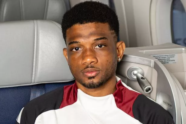 Amad of Manchester United checks in ahead of their flight to Kuala Lumpur for the first stage of their post-season tour at Manchester Airport