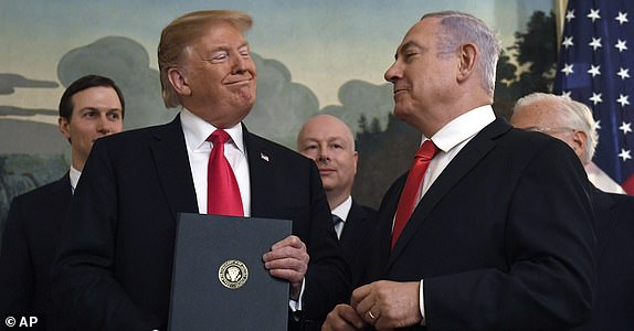 FILE - In this March 25, 2019 file photo, President Donald Trump smiles at Israeli Prime Minister Benjamin Netanyahu, right, after signing a proclamation at the White House in Washington. (AP Photo/Susan Walsh, File)