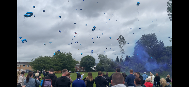Balloons were released for Greg