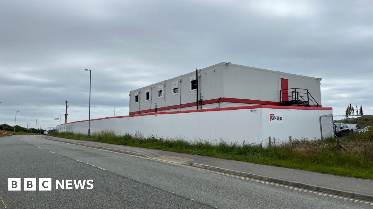 Photograph of the outside of the BCP site. It is a white building with white fencing, and "Kier" can be seen on the side of the site.