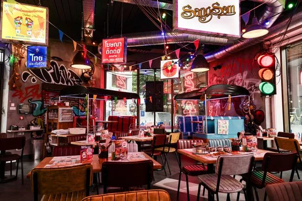 The restaurant even features a red and blue booth tuk-tuk, representing Manchester's football colours