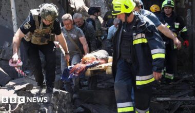Emergency services in Dnipro carry a wounded person out of a building damaged in a Russian missile attack, 24 June 2025