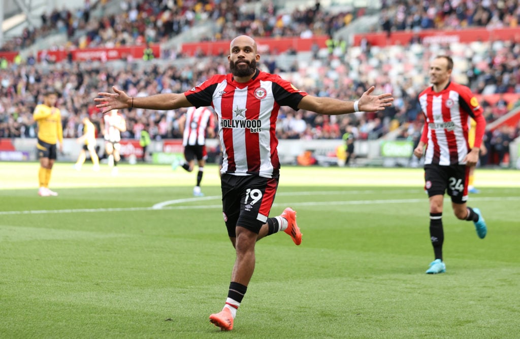 Bryan Mbeumo celebrates with arms outstretched against Wolves
