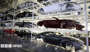 Car bodies are stored on shelves at the Aston Martin factory in Gaydon, Britain