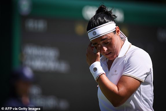 Tunisia's Ons Jabeur reacts as she plays against Bulgaria's Viktoriya Tomova during their women's singles first round tennis match on the first day of the 2025 Wimbledon Championships at The All England Lawn Tennis and Croquet Club in Wimbledon, southwest London, on June 30, 2025. (Photo by HENRY NICHOLLS / AFP) / RESTRICTED TO EDITORIAL USE (Photo by HENRY NICHOLLS/AFP via Getty Images)