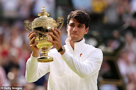 LONDON, ENGLAND - JULY 14: Carlos Alcaraz of Spain poses with the Gentlemen's Singles Trophy following victory against Novak Djokovic of Serbia in the Gentlemen's Singles Final during day fourteen of The Championships Wimbledon 2024 at All England Lawn Tennis and Croquet Club on July 14, 2024 in London, England. (Photo by Julian Finney/Getty Images)